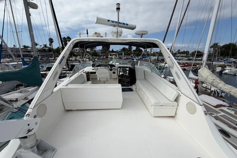 Slide: The Image of 1998 Bayliner 4788 Pilot House Motoryacht with spacious deck and seating in marina. - 42