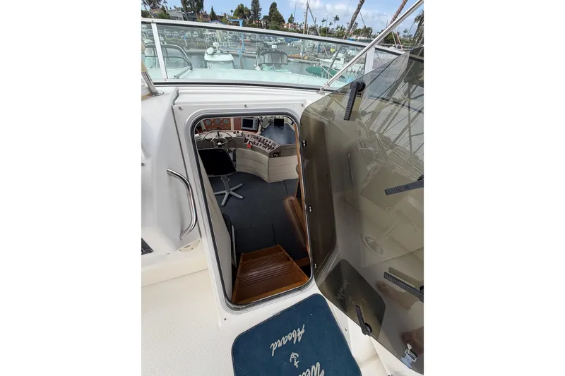 Slide: The Image of 1998 Bayliner 4788 Pilot House Motoryacht interior view with helm and seating area. - 47