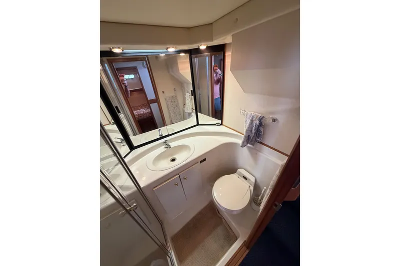 Slide: The Image of Bathroom interior of 1998 Bayliner 4788 Pilot House Motoryacht, featuring sink and toilet. - 51