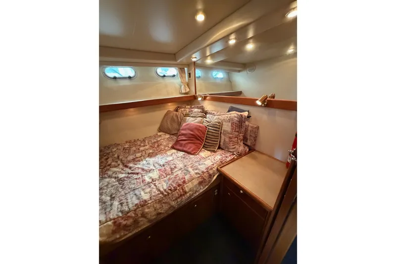 Slide: The Image of Cozy cabin interior of 1998 Bayliner 4788 Pilot House Motoryacht with plush bedding. - 54