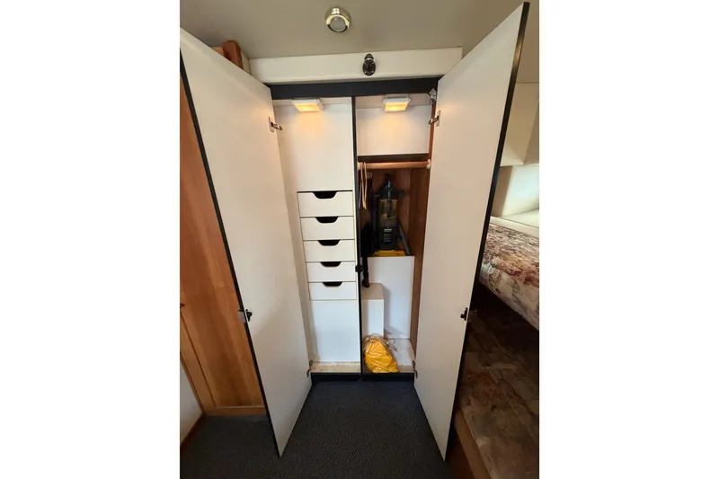 Slide: The Image of Open closet with drawers and vacuum in 1998 Bayliner 4788 Pilot House Motoryacht. - 59