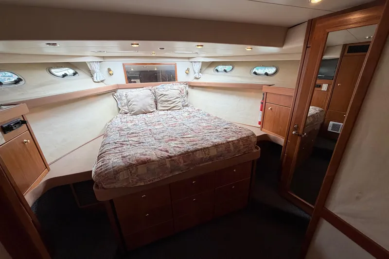 Slide: The Image of Luxurious bedroom in 1998 Bayliner 4788 Pilot House Motoryacht with cozy bed and wooden cabinetry. - 60