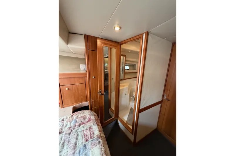 Slide: The Image of Interior of 1998 Bayliner 4788 Pilot House Motoryacht with wooden cabinetry and bathroom. - 62