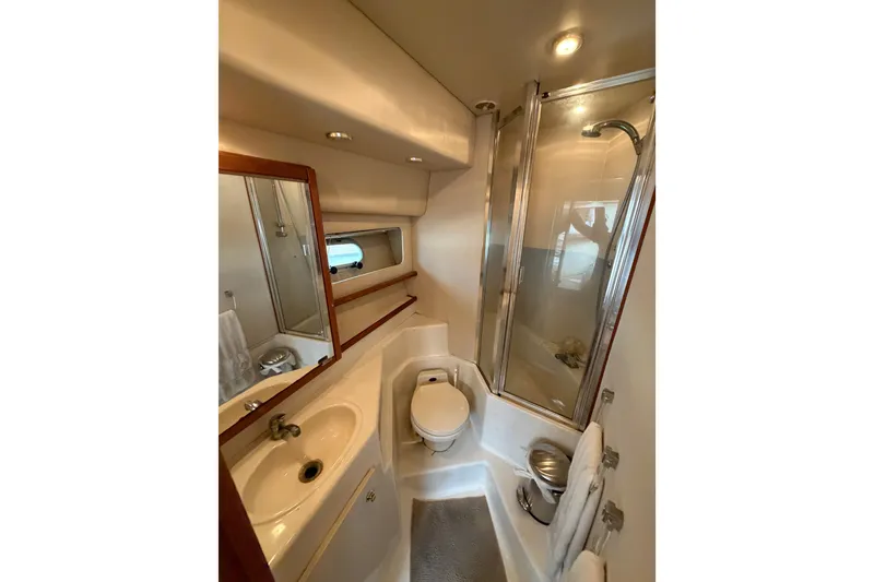 Slide: The Image of 1998 Bayliner 4788 Pilot House Motoryacht bathroom with shower, sink, and toilet. - 63