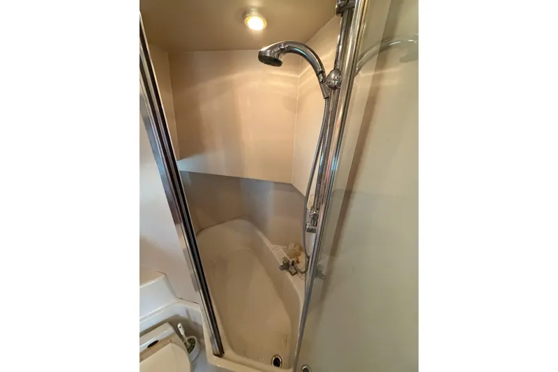 Slide: The Image of Shower area in 1998 Bayliner 4788 Pilot House Motoryacht, featuring chrome fixtures and enclosed design. - 64