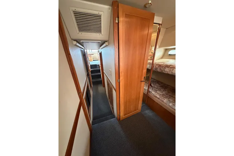 Slide: The Image of Interior hallway of 1998 Bayliner 4788 Pilot House Motoryacht with wooden door and bunk beds. - 67