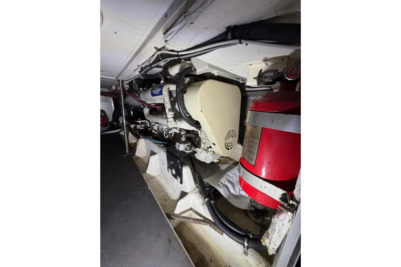 Slide: The Image of Engine room of 1998 Bayliner 4788 Pilot House Motoryacht with visible fire extinguisher. - 74