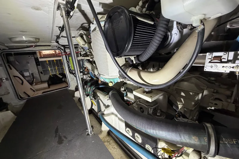 Slide: The Image of Engine room of 1998 Bayliner 4788 Pilot House Motoryacht, showcasing mechanical components. - 76