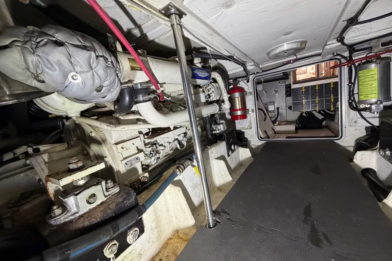Slide: The Image of Engine room of 1998 Bayliner 4788 Pilot House Motoryacht, showcasing mechanical components and equipment. - 77