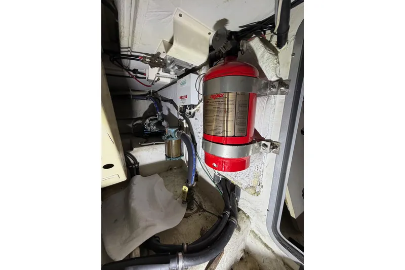 Slide: The Image of Engine room of 1998 Bayliner 4788 Pilot House Motoryacht with fire extinguisher. - 78
