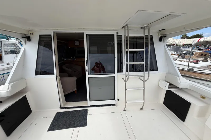 Slide: The Image of 1998 Bayliner 4788 Pilot House Motoryacht interior with sliding doors and ladder. - 8