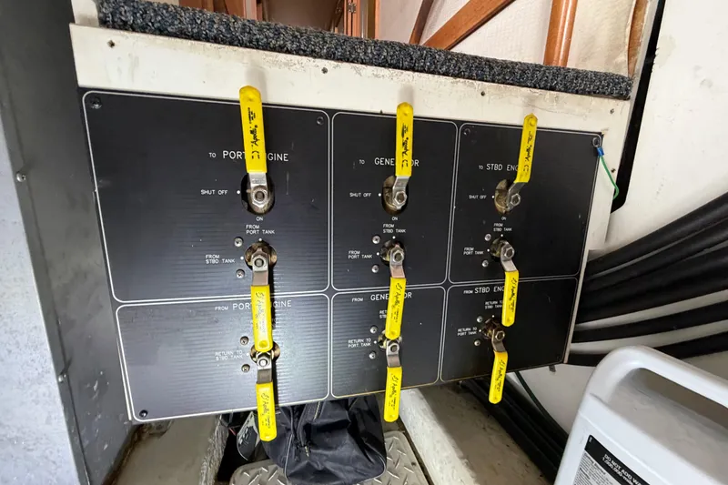 Slide: The Image of Control panel of a 1998 Bayliner 4788 Pilot House Motoryacht with labeled yellow levers. - 80