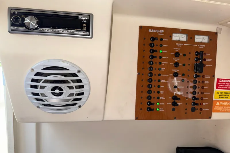 Slide: The Image of 2007 Mainship Pilot 30 Sedan control panel with JVC stereo and speaker. - 16