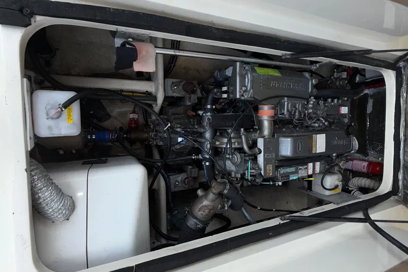 Slide: The Image of Engine compartment of 2007 Mainship Pilot 30 Sedan, showcasing detailed mechanical components. - 25