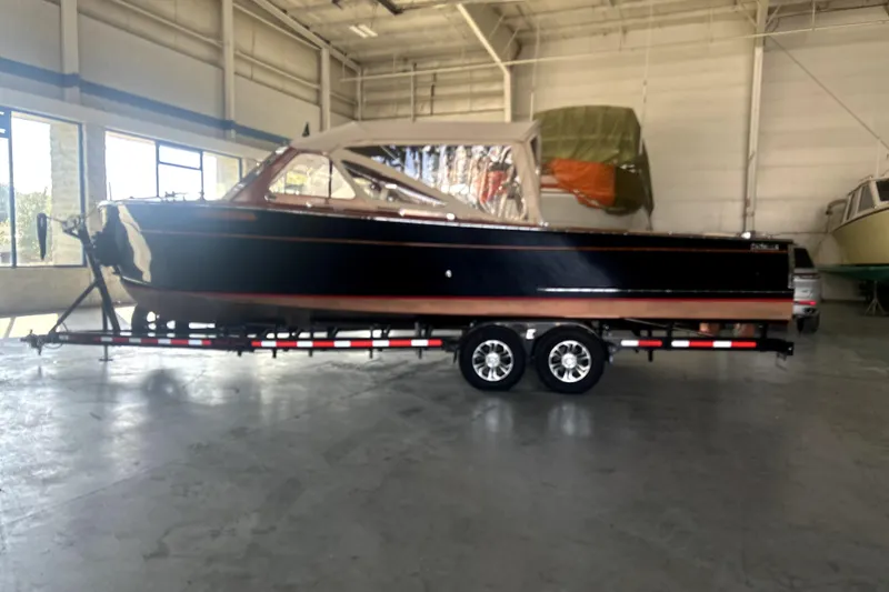 The Image of 1962 Prowler Forest Johnson boat on trailer in indoor storage facility. - 0