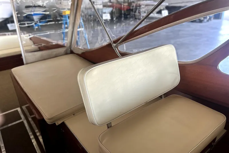Slide: The Image of Interior of a 1962 Prowler Forest Johnson boat with beige seating and wooden accents. - 11