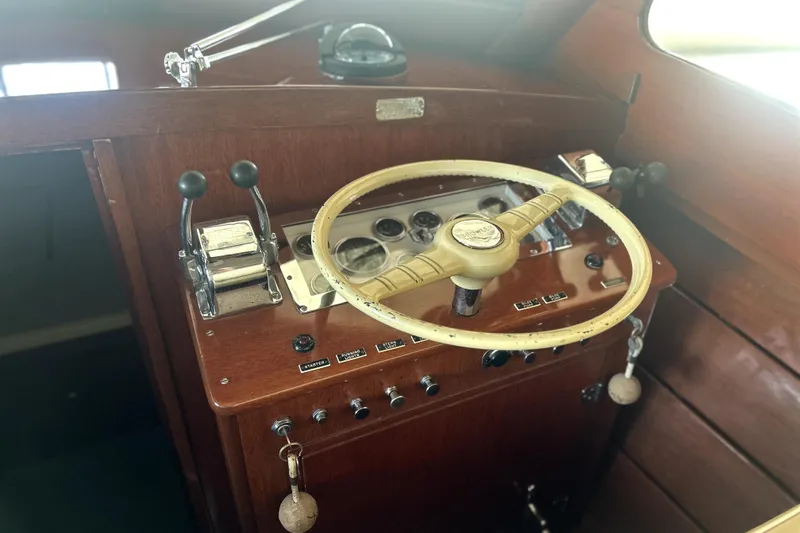Slide: The Image of 1962 Prowler Forest Johnson boat dashboard with vintage steering wheel and controls. - 12