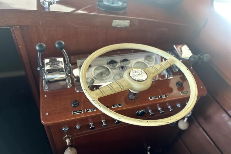 Slide: The Image of 1962 Prowler Forest Johnson boat dashboard with vintage steering wheel and controls. - 13