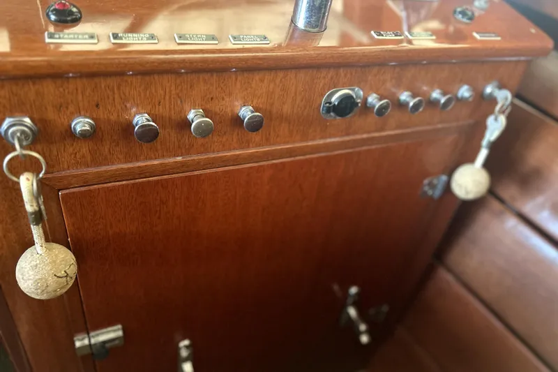 Slide: The Image of 1962 Prowler Forest Johnson boat dashboard with vintage controls and keychains. - 15