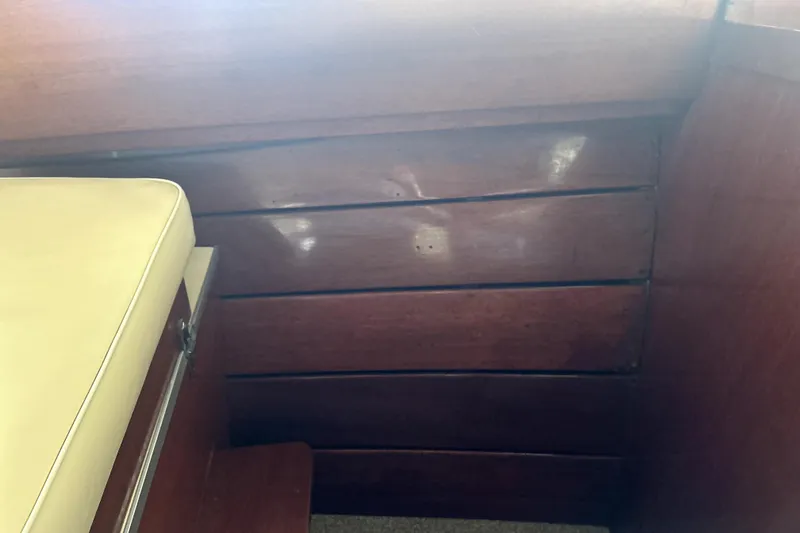 Slide: The Image of Wooden interior of a 1962 Prowler Forest Johnson boat with beige seating. - 17