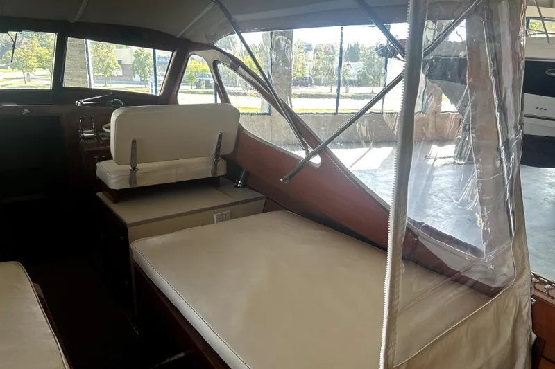 Slide: The Image of Interior of a 1962 Prowler Forest Johnson boat with beige seating and clear windows. - 22