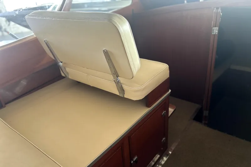 Slide: The Image of 1962 Prowler Forest Johnson boat interior with beige seating and wooden cabinetry. - 24