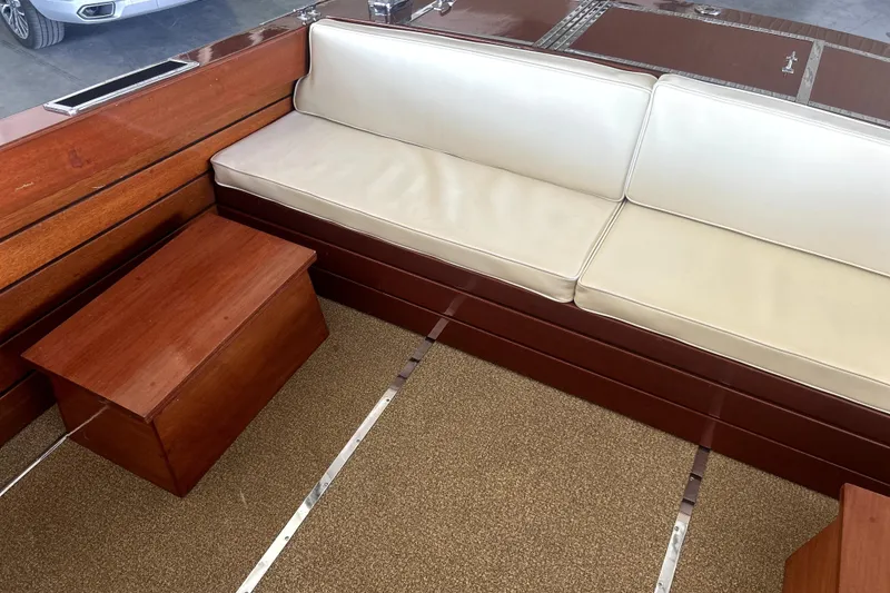 Slide: The Image of 1962 Prowler Forest Johnson boat interior with white seating and wooden accents. - 25