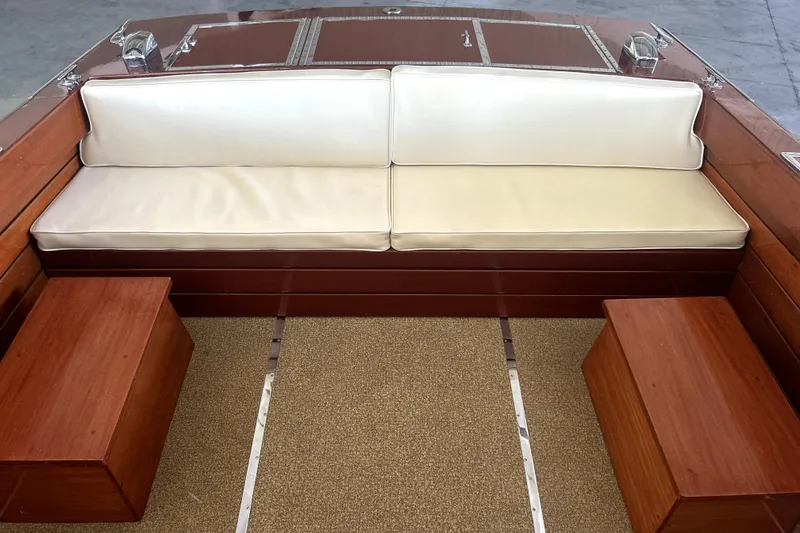 Slide: The Image of 1962 Prowler Forest Johnson boat interior with white cushioned seating and wooden accents. - 26