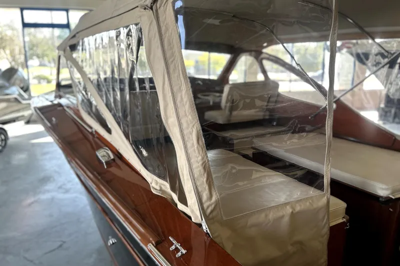Slide: The Image of 1962 Prowler Forest Johnson boat with beige canopy and polished wood finish. - 29