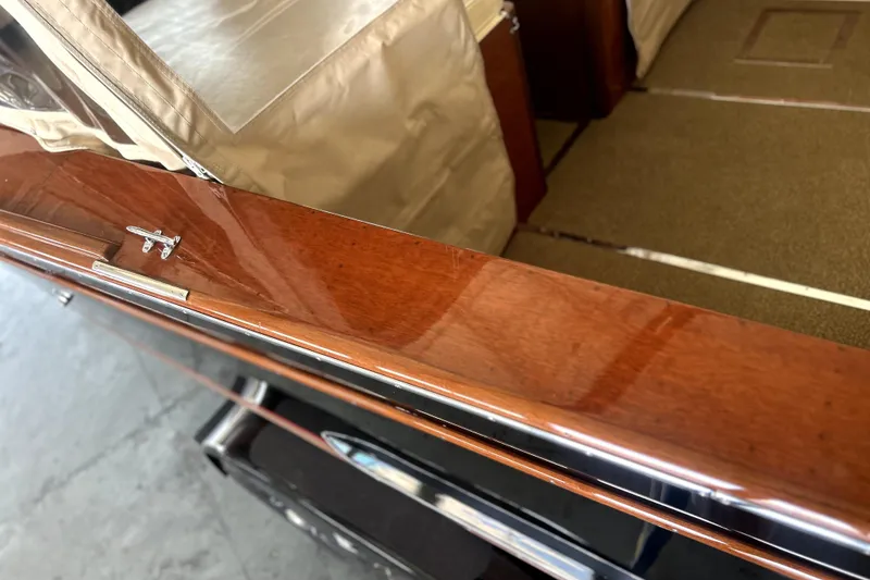 Slide: The Image of Polished wood interior of a 1962 Prowler Forest Johnson boat, featuring beige upholstery. - 30