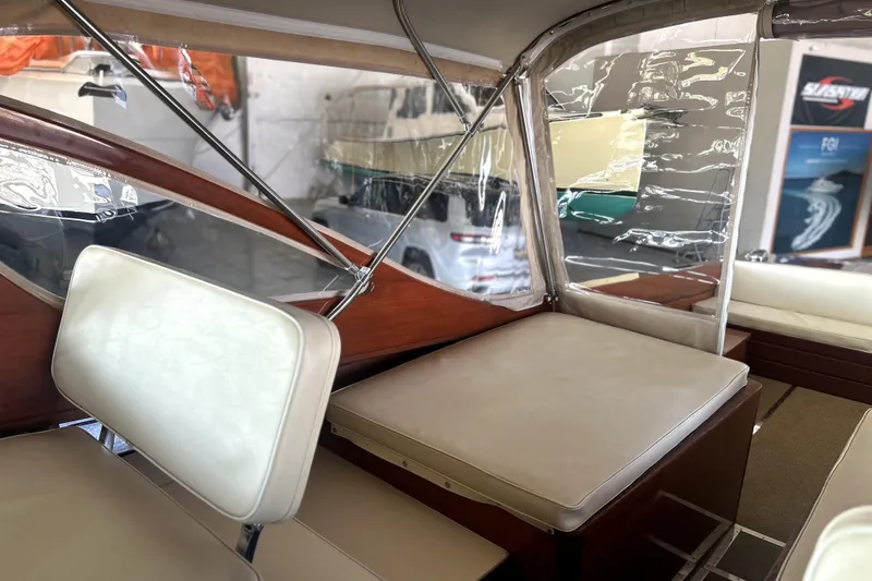 Slide: The Image of Interior of a 1962 Prowler Forest Johnson boat with white seating and clear canopy. - 35