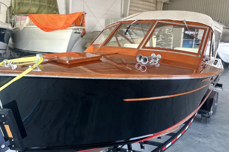 Slide: The Image of 1962 Prowler Forest Johnson boat with polished wood finish in a storage facility. - 41