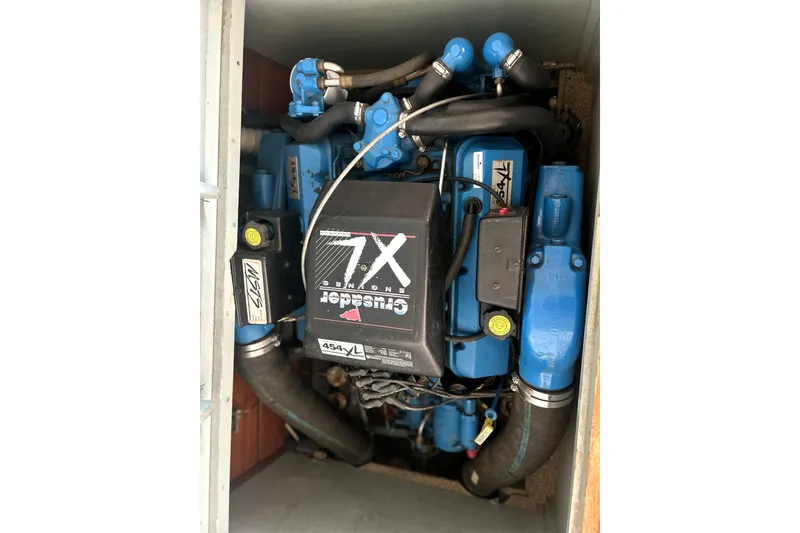 Slide: The Image of Engine of a 1962 Prowler Forest Johnson boat, featuring a blue Crusader 7X motor. - 44