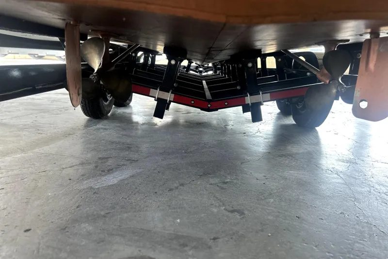 Slide: The Image of Underside view of a 1962 Prowler Forest Johnson boat with visible propellers and trailer. - 6