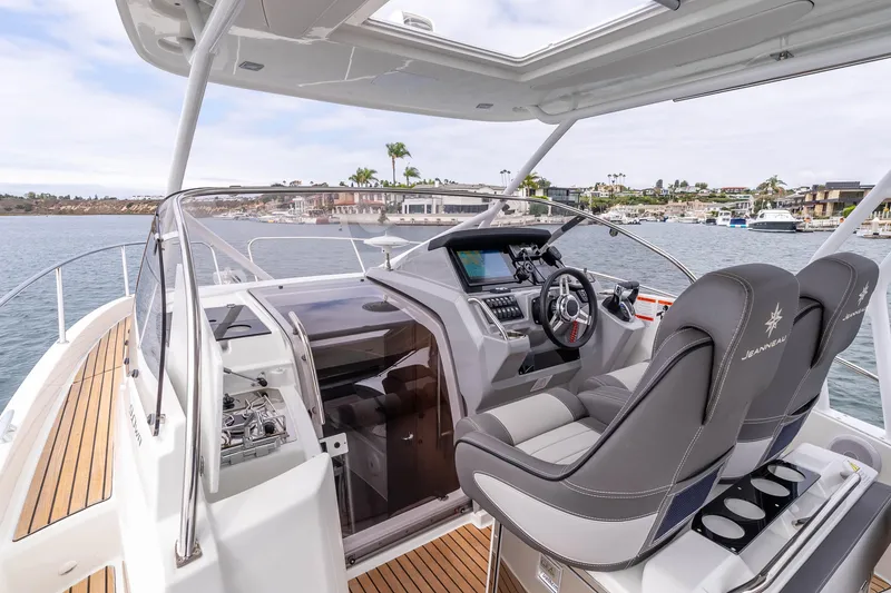 Slide: The Image of 2023 Jeanneau Leader 9.0 WA boat interior with modern helm and luxurious seating. - 11