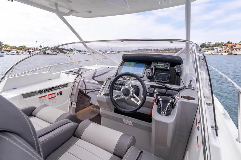 Slide: The Image of 2023 Jeanneau Leader 9.0 WA boat cockpit with modern navigation equipment and comfortable seating. - 13