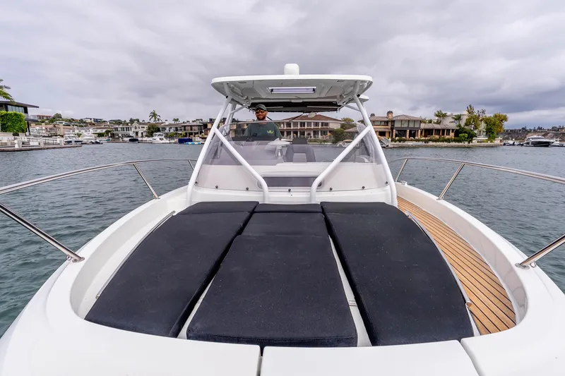 Slide: The Image of 2023 Jeanneau Leader 9.0 WA boat on water, featuring spacious deck and modern design. - 16