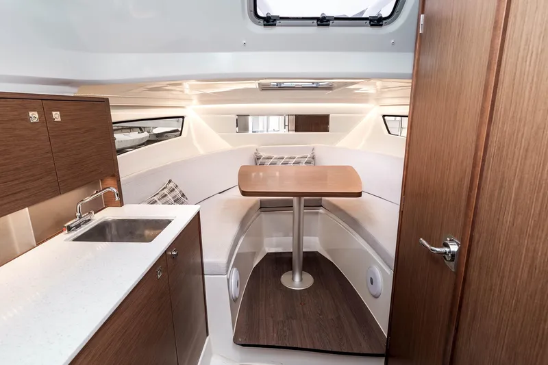 Slide: The Image of 2023 Jeanneau Leader 9.0 WA cabin interior with seating and kitchenette. - 17
