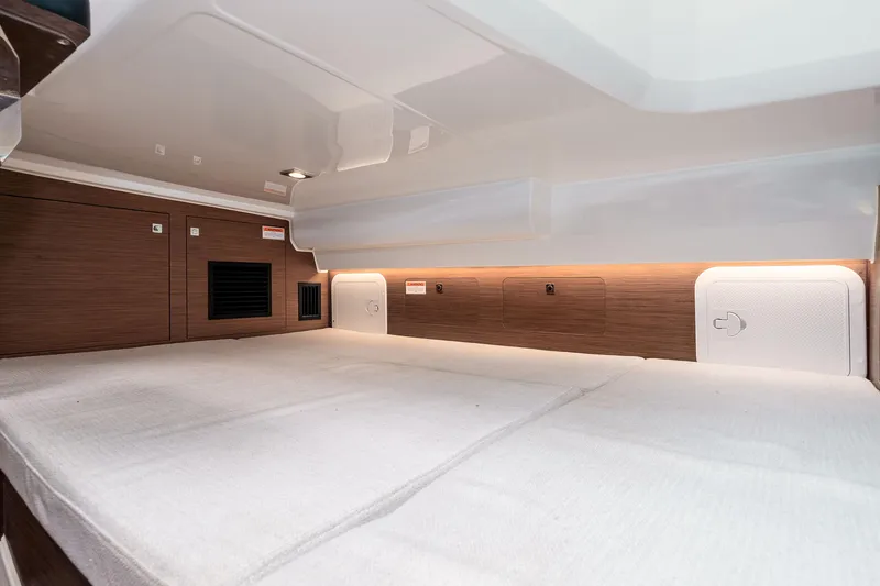 Slide: The Image of 2023 Jeanneau Leader 9.0 WA cabin interior with modern wood finish and ambient lighting. - 20