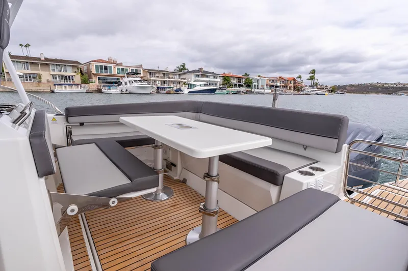 Slide: The Image of 2023 Jeanneau Leader 9.0 WA boat with spacious seating and table on deck. - 9