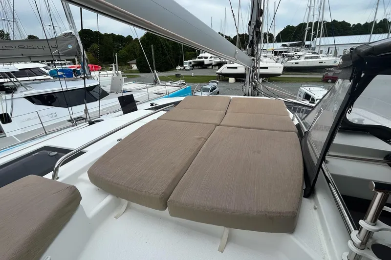 Slide: The Image of 2019 Fountaine Pajot Helia 44 Evolution catamaran with cushioned deck seating in marina. - 10