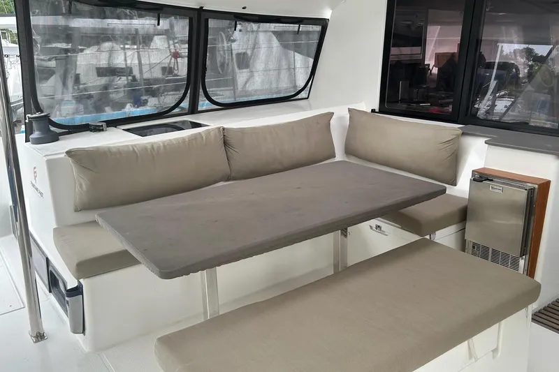 Slide: The Image of 2019 Fountaine Pajot Helia 44 Evolution yacht interior with cushioned seating and table. - 31