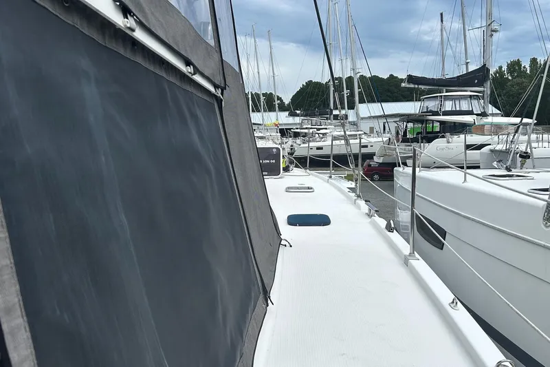 Slide: The Image of 2019 Fountaine Pajot Helia 44 Evolution catamaran docked in a marina, surrounded by other boats. - 39