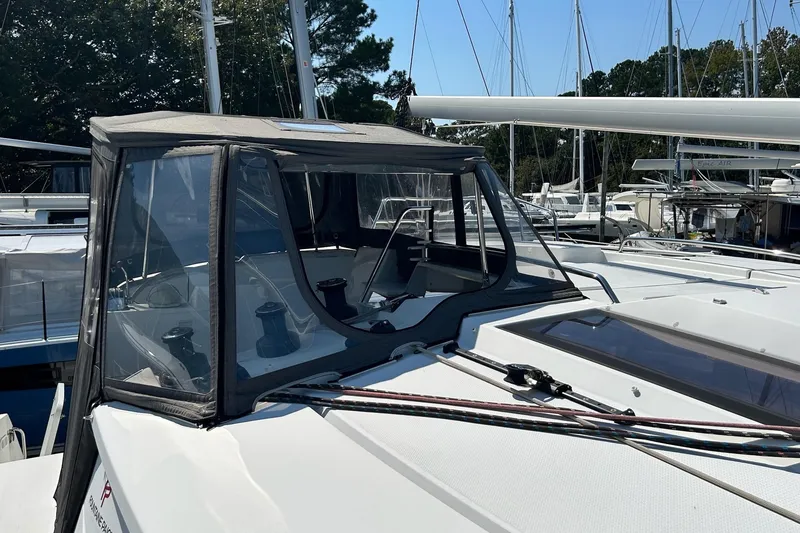 Slide: The Image of 2019 Fountaine Pajot Helia 44 Evolution catamaran with covered cockpit, docked in marina. - 4