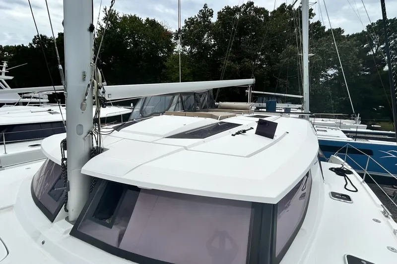 Slide: The Image of 2019 Fountaine Pajot Helia 44 Evolution catamaran docked, showcasing sleek design and spacious deck. - 41