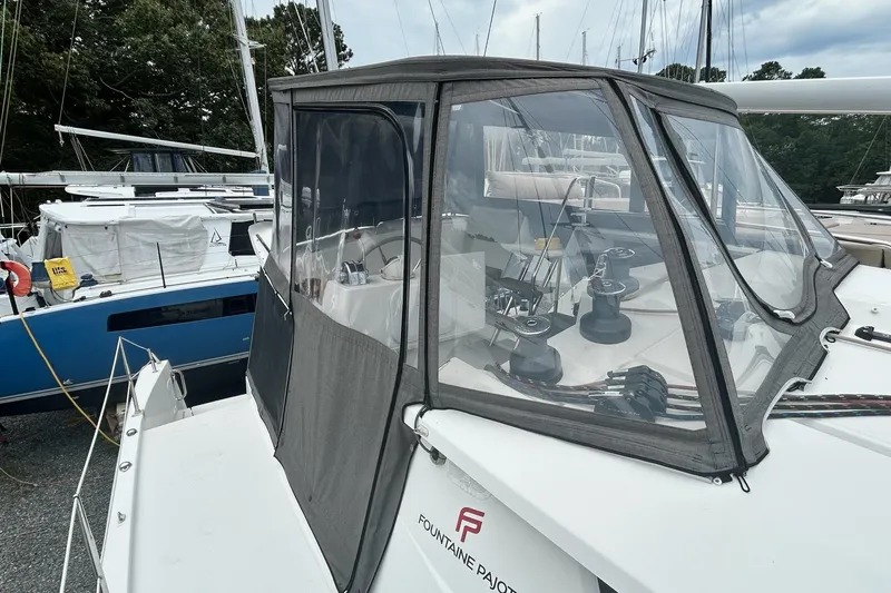Slide: The Image of 2019 Fountaine Pajot Helia 44 Evolution catamaran with enclosed cockpit at marina. - 42