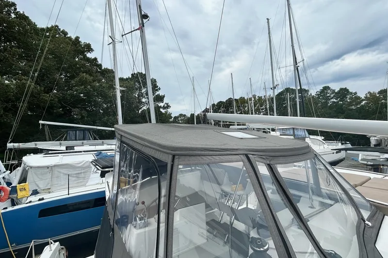 Slide: The Image of 2019 Fountaine Pajot Helia 44 Evolution catamaran docked, surrounded by trees and other boats. - 43