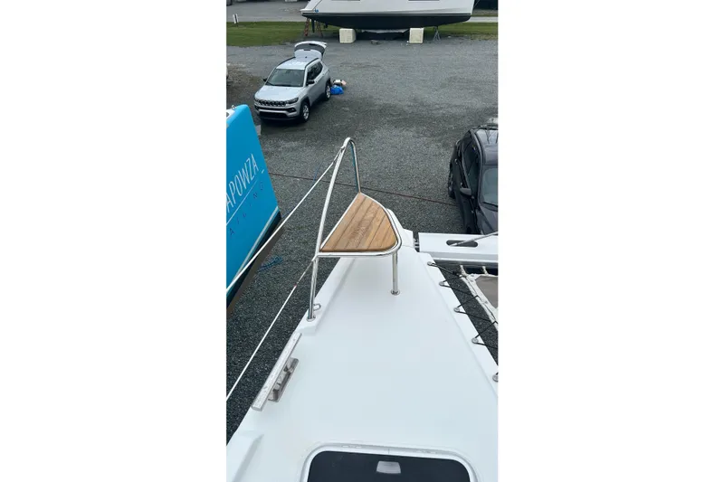 Slide: The Image of 2019 Fountaine Pajot Helia 44 Evolution catamaran on land, with visible deck and surroundings. - 49