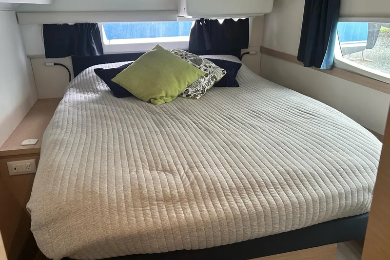 Slide: The Image of Cozy bedroom in 2019 Fountaine Pajot Helia 44 Evolution yacht with pillows and natural light. - 52