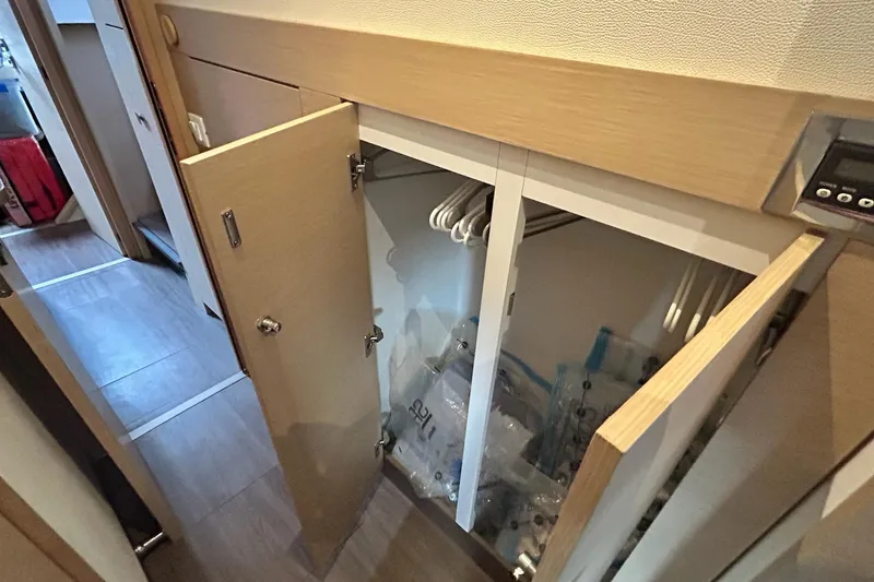 Slide: The Image of 2019 Fountaine Pajot Helia 44 Evolution interior closet with open doors and hangers. - 53
